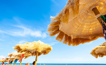 thatched umbrellas and bright turquoise sea, great recreation and relaxation.