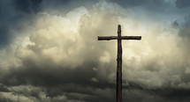 cross against gray clouds in the sky 