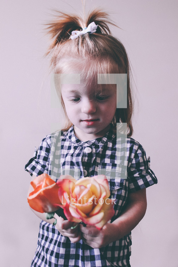 Girl holding roses.