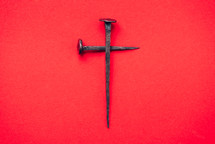 Cross made from nails on a red background - Good Friday