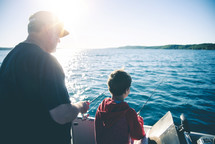 father and son fishing on a boat 