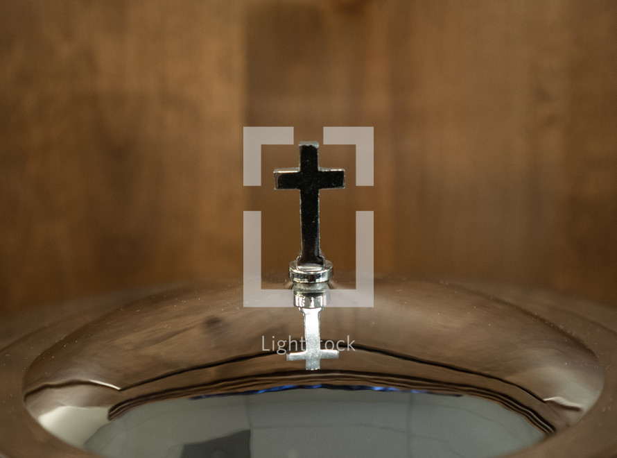 Close up of the cross on a communion tray at a church service