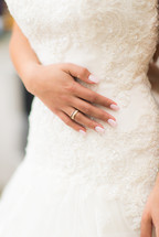 brides hand on her dress 