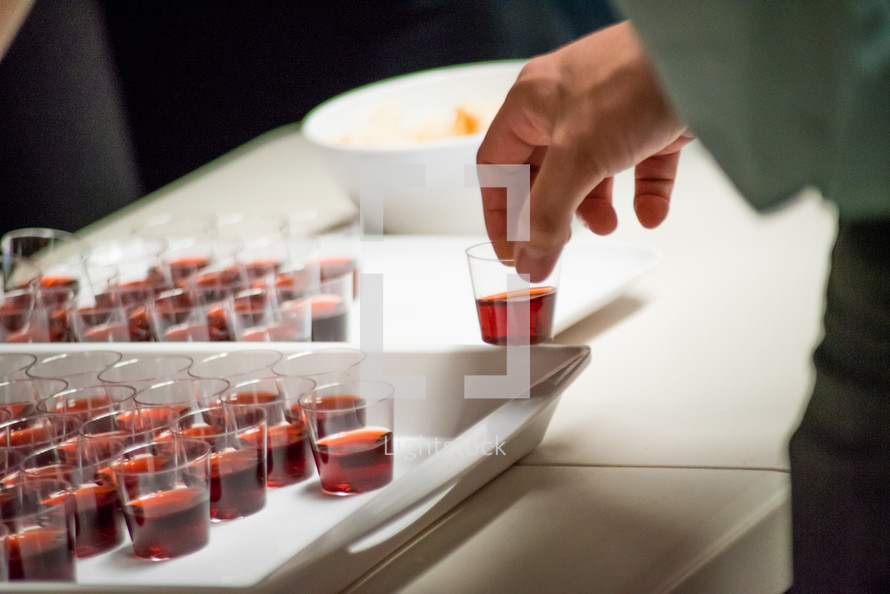 communion wine in cups on a tray 