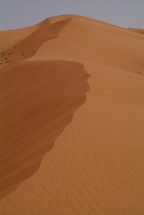 Desert sand dunes blown by the wind