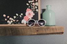 sunglasses on a shelf 