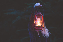 a woman holding a lantern 