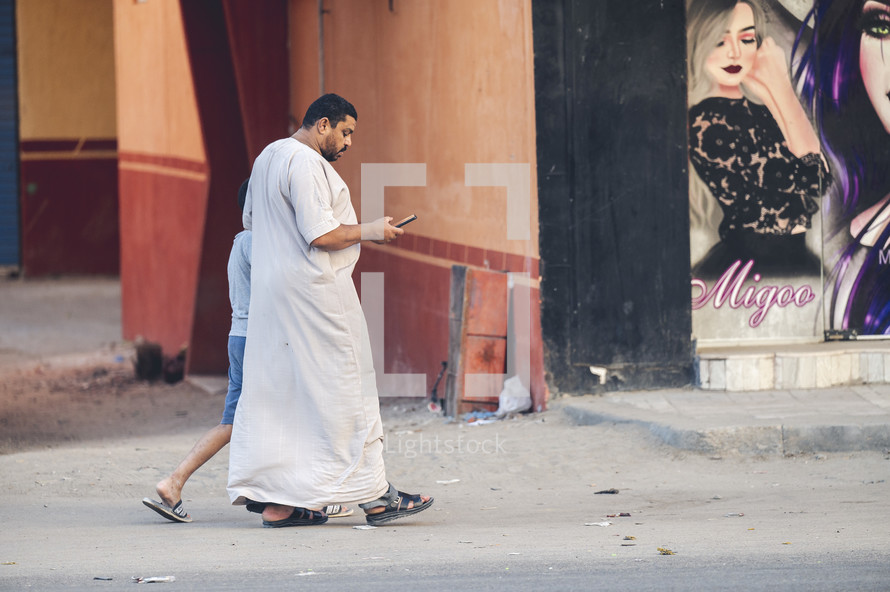 father and son walking on the streets of Egypt 
