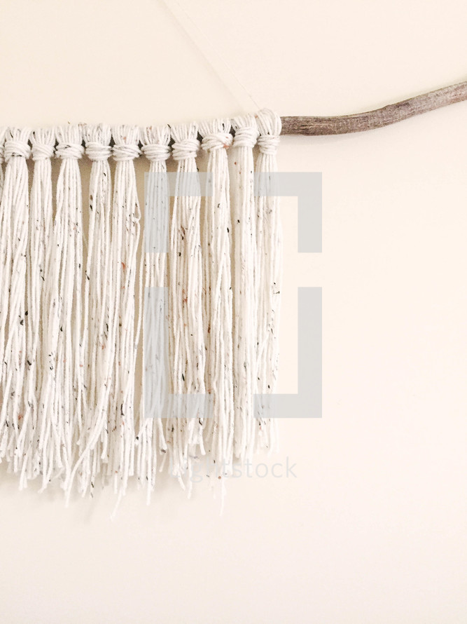 yarn tassels on a branch 