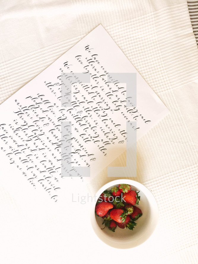 a note and strawberries in a bowl 