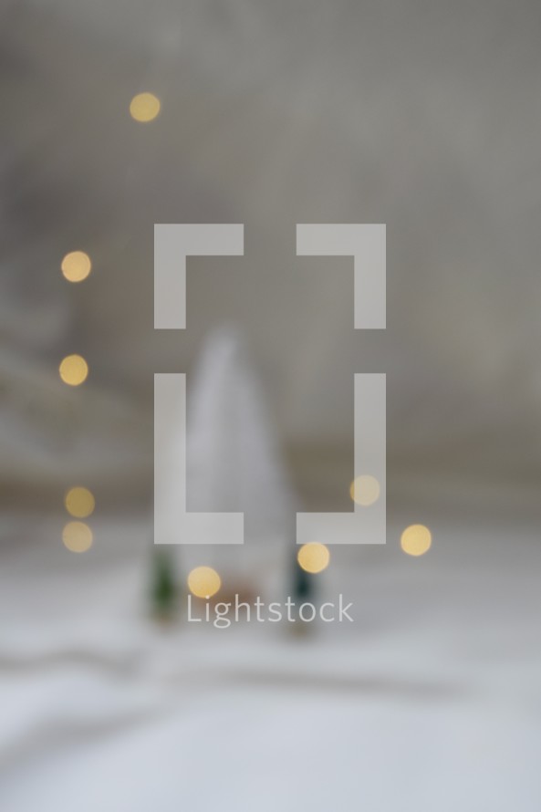 Bokeh lights with Christmas trees against white background 