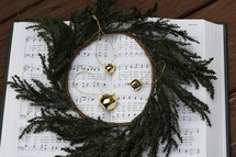 hymnal with bells and wreath 