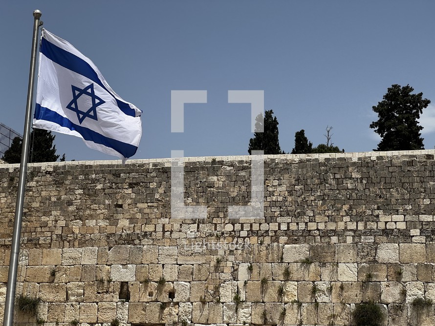 The Israel flag flying over the Western Wall