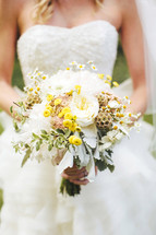 torso bride holding a bouquet of flowers
