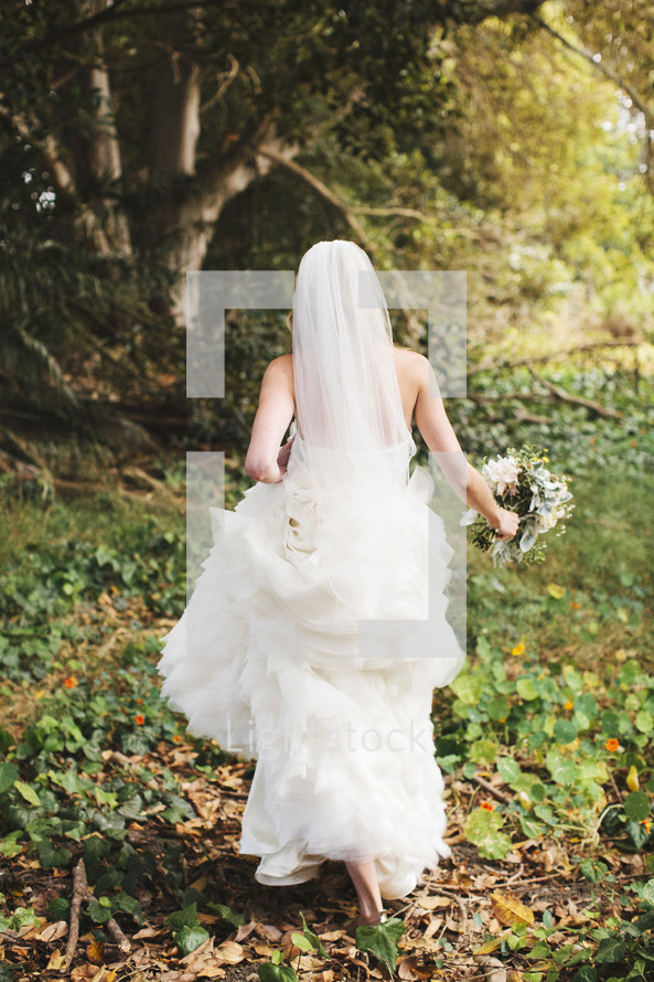 bride running through ivy on the ground outdoors