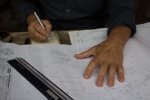 a man working on blueprint plans 