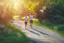 couple jogging on a path outdoors 
