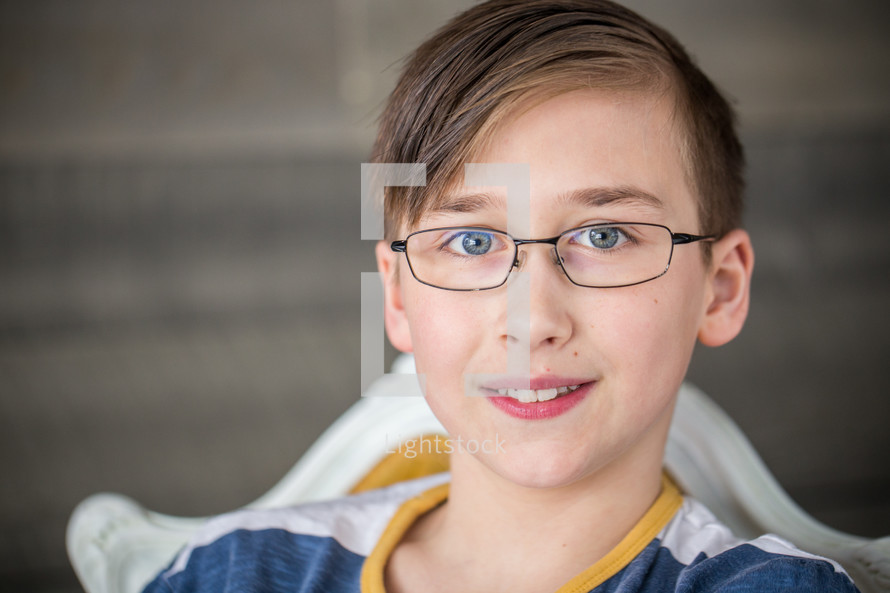 face of a boy in glasses 