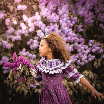 girl surrounded by purple flowers 