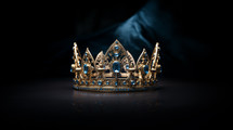 Bible times crown with blue jewels on a dark background. 