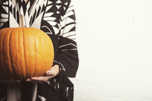 woman holding a pumpkin 