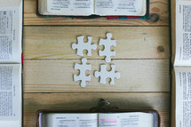 open Bibles and puzzle pieces 