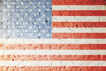 American flag painted on a brick wall
