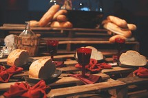Bread and juice are displayed on a table setting for communion at a Good Friday Lord's Supper.