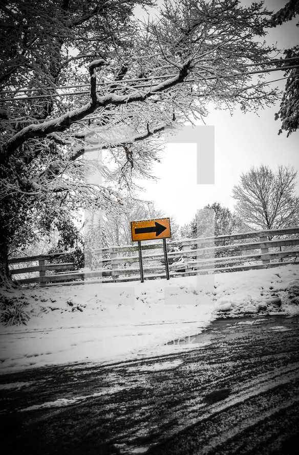 street sign and fence with snow 