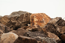 A pile of boulders against a white sky