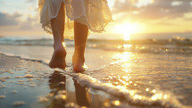Woman walking on beach at sunset, golden hour light, reflective water.