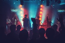 musicians singing on stage at a worship service 