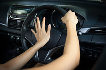 a woman's hands on a steering wheel 