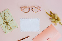 reading glasses and stationary on a desk 