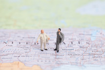 figurines standing on a map of the United States 