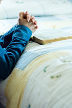 praying beside the bed with a bible