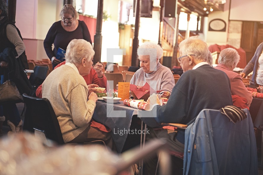 elderly couple eating at a church banquet 