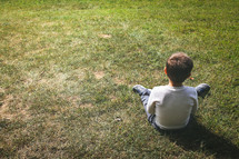 boy sitting in grass