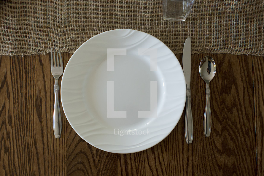 A place setting on a wooden table.