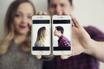 kissing couple on cellphones