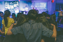 congregation embracing during a worship service 