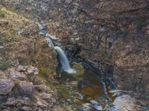 A large waterfall in a desert oasis