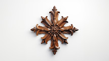 A wooden cross with detailed ornaments. Set against a white background. 