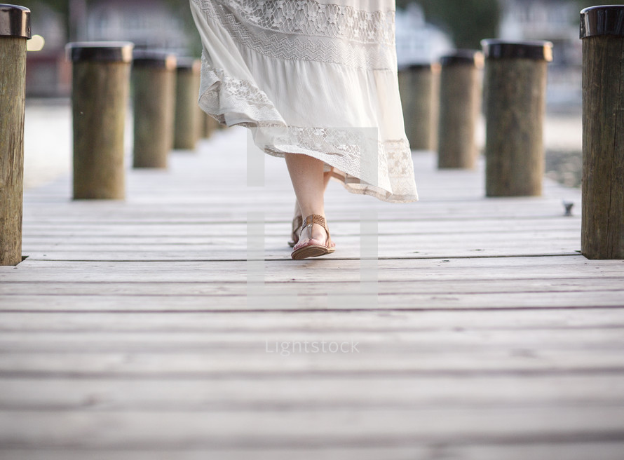 woman walking on a dock 