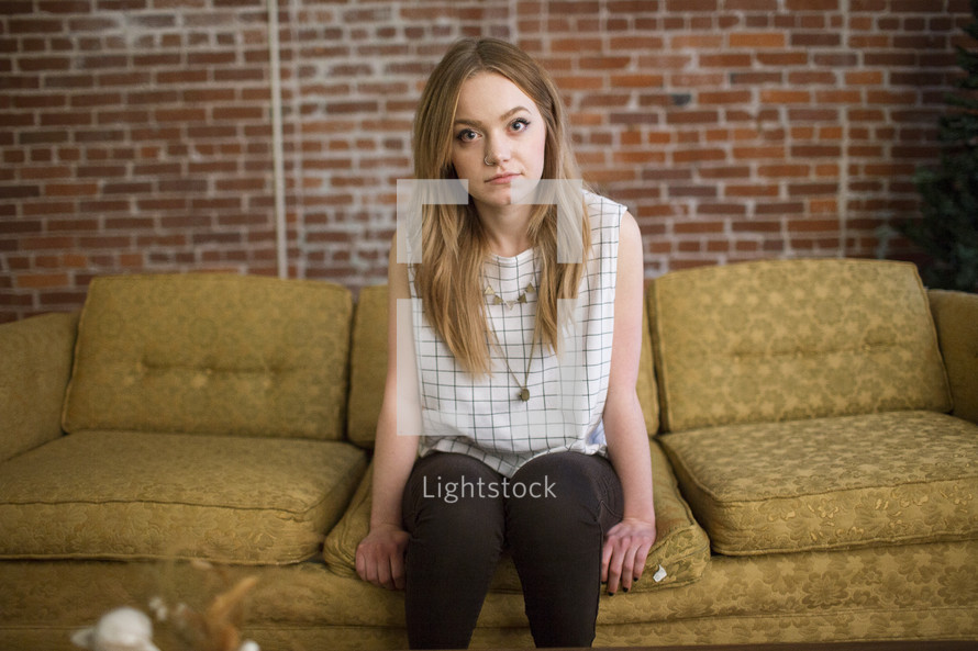 a young woman sitting on a couch 