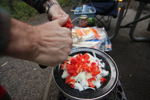 cutting vegetables to cook while camping 