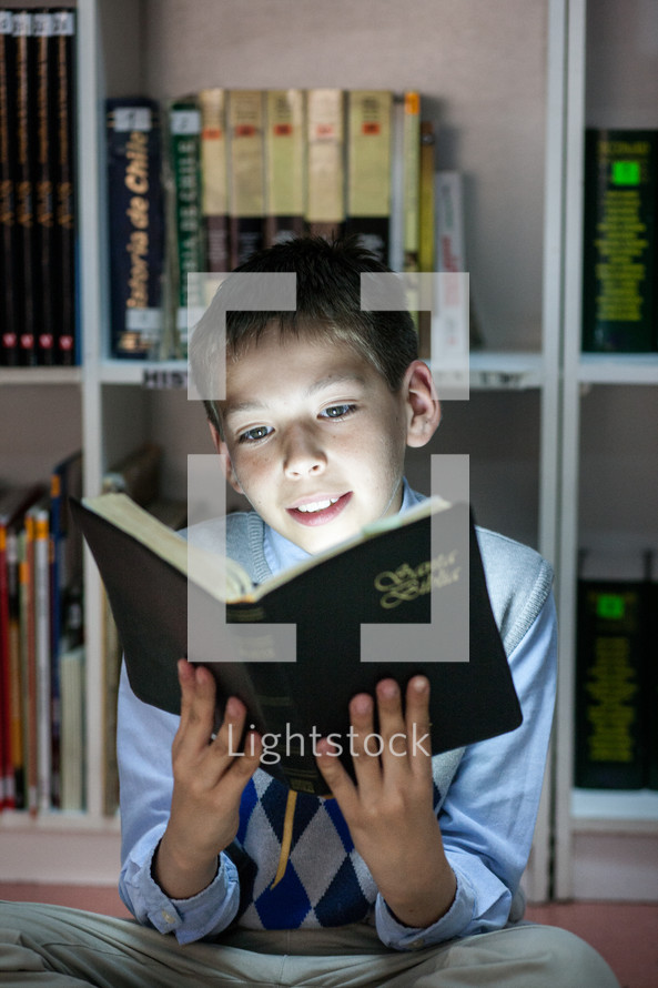 Kid reading the Holy Bible