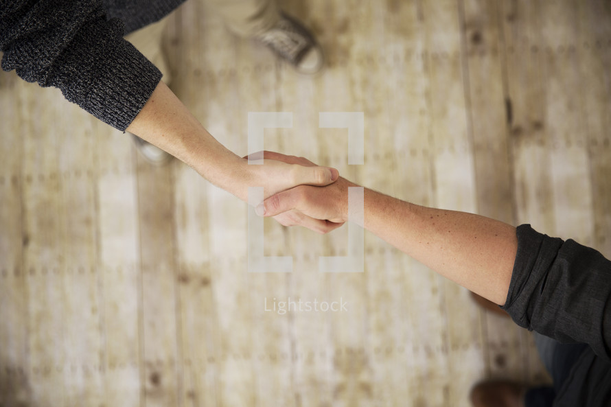 a handshake between two people. 