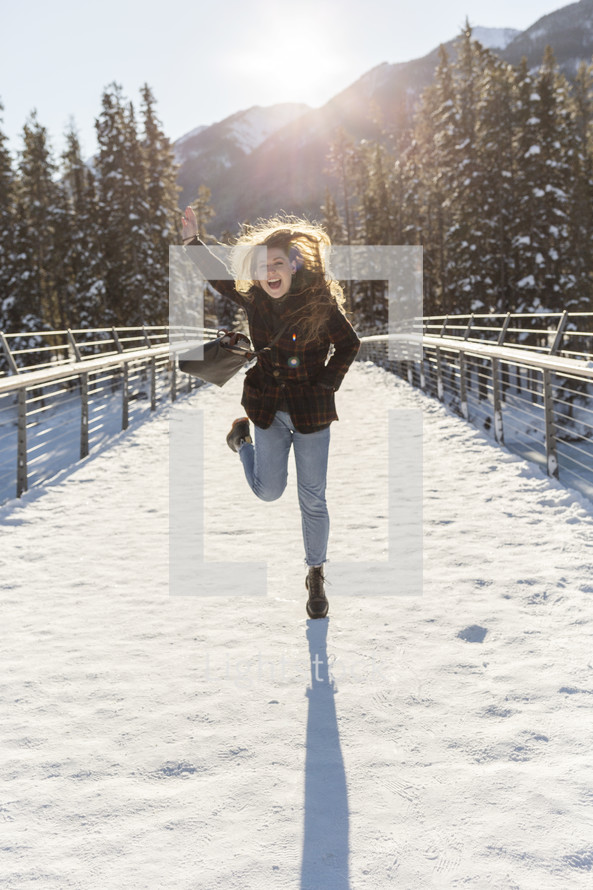 woman celebrating outdoors in snow 