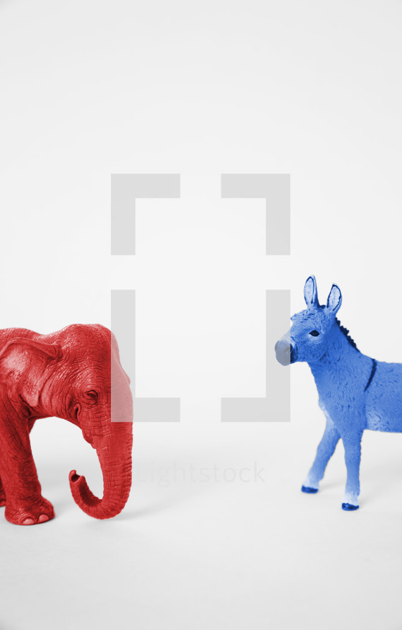 A red Republican elephant and a blue Democratic donkey facing off.